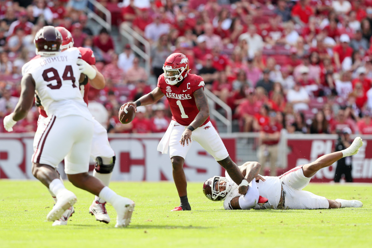 Oct 21, 2023; Fayetteville, Arkansas, USA; Mississippi State Bulldogs linebacker Nathaniel Watson (14) holds on to Arkansas Razorbacks quarterback KJ Jefferson during the first half at Donald W. Reynolds Razorback Stadium. Mandatory Credit: Nelson Chenault-USA TODAY Sports